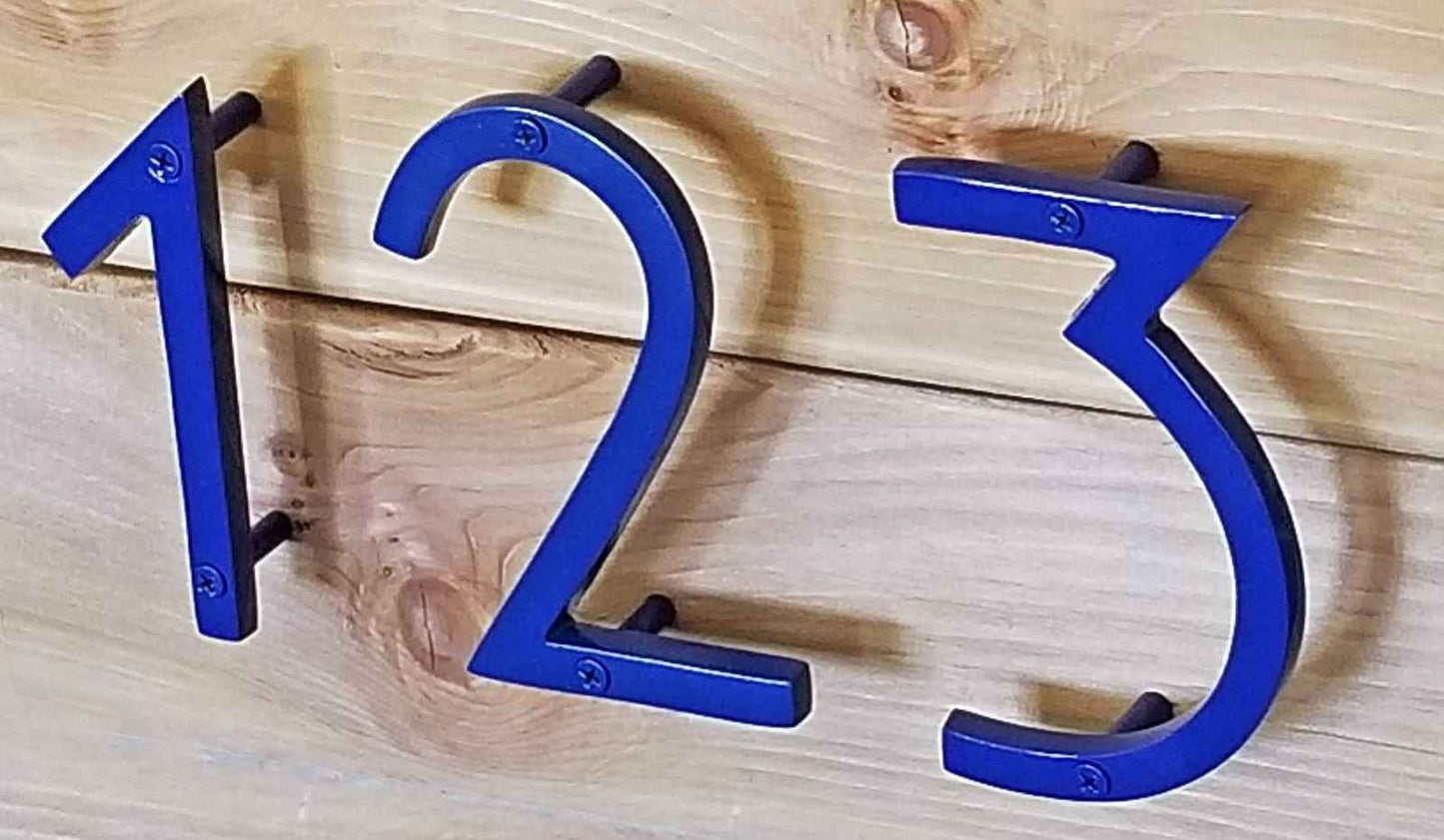 Stylish blue house number one displayed on a wooden surface for home decor
