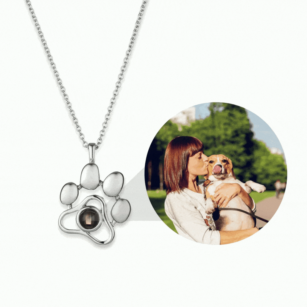 Custom pet photo necklace in silver with a paw design and photo of a woman with a dog
