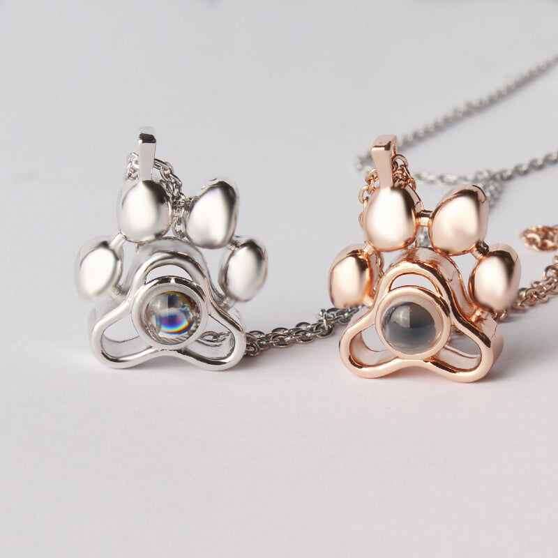 Custom pet photo necklace in silver and rose gold featuring a paw print design with a photo locket
