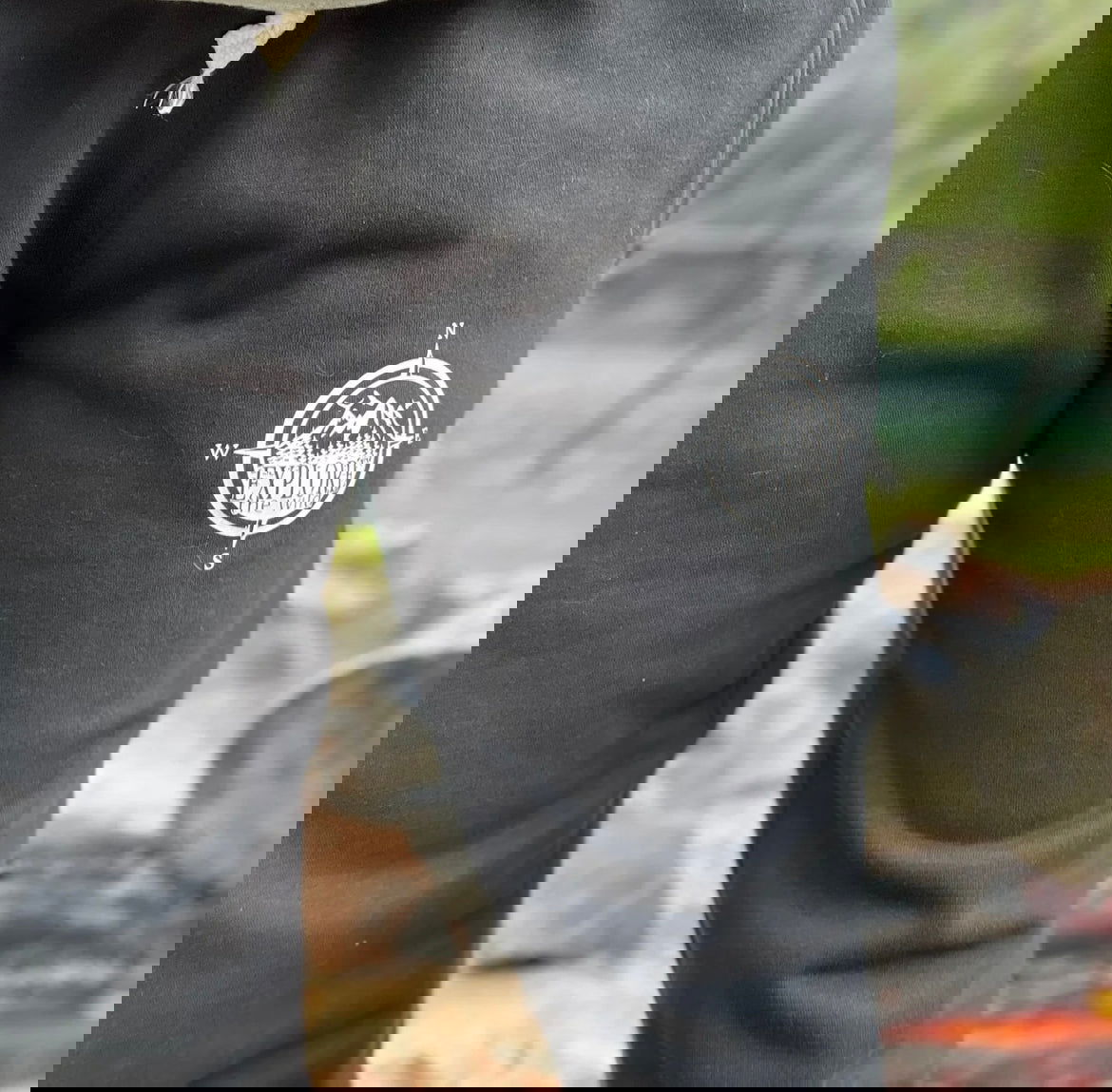 Explore Sweatpants Canada in black with a compass logo, perfect for outdoor adventures