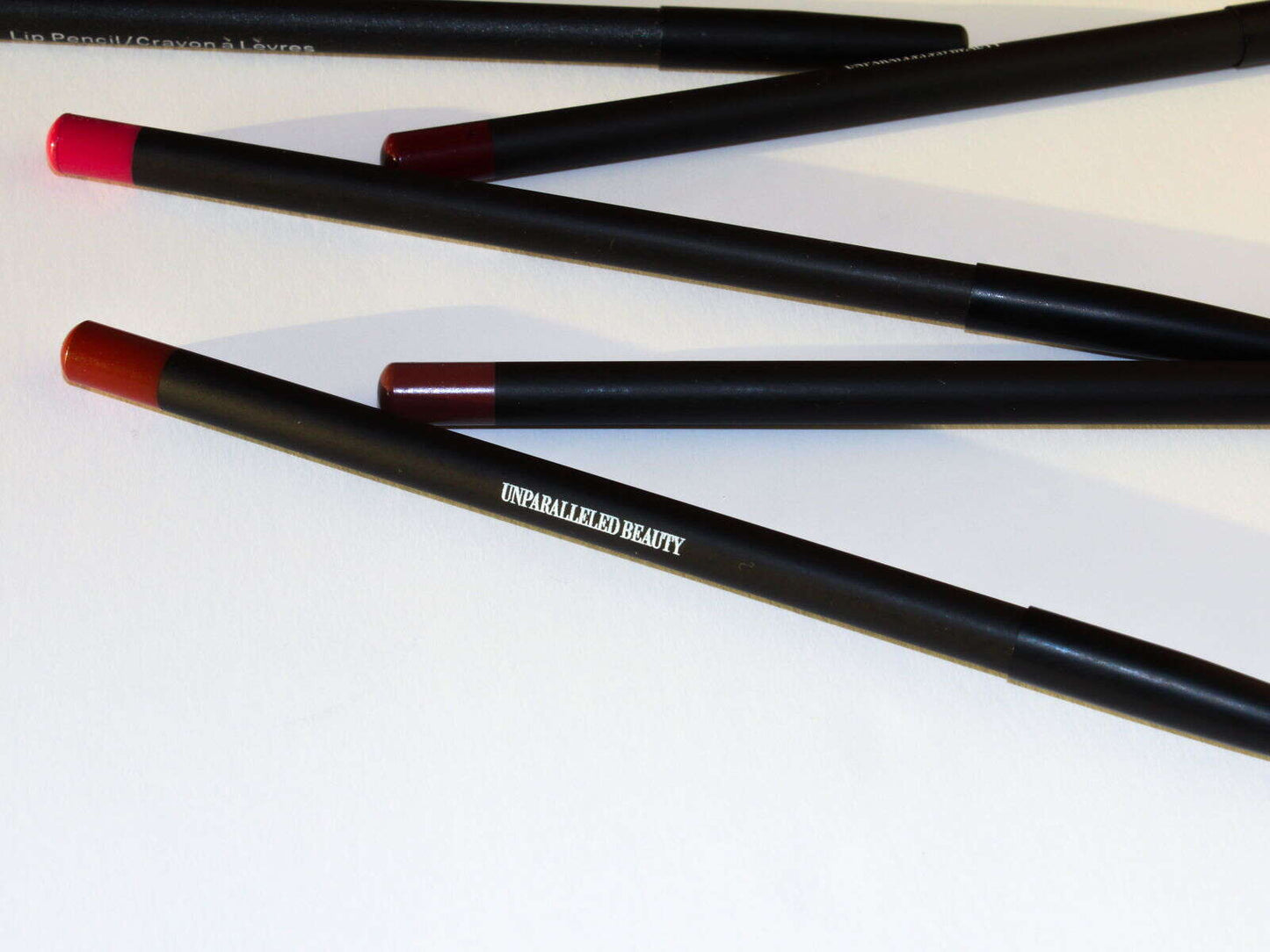 UNPARALLELED BEAUTY Uptown Red lip pencil alongside other shades for a complete lip makeup look