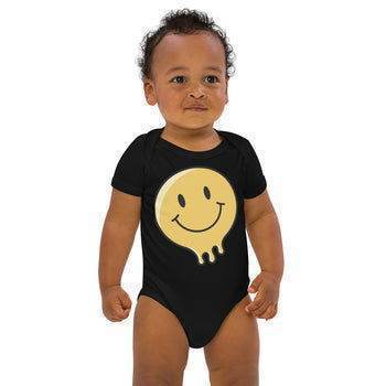 Cute baby in a black onesie featuring a smiley face, part of the Canadian baby clothing collection
