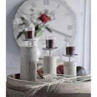 Canadian candle collection featuring elegant candles placed on a rustic tray with decorative elements