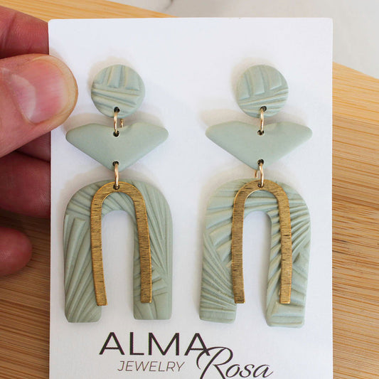 PERSONA Earrings.  Textured Sage Green Polymer Clay Arch earrings with brass dangles - Www.Shopthatapp.com