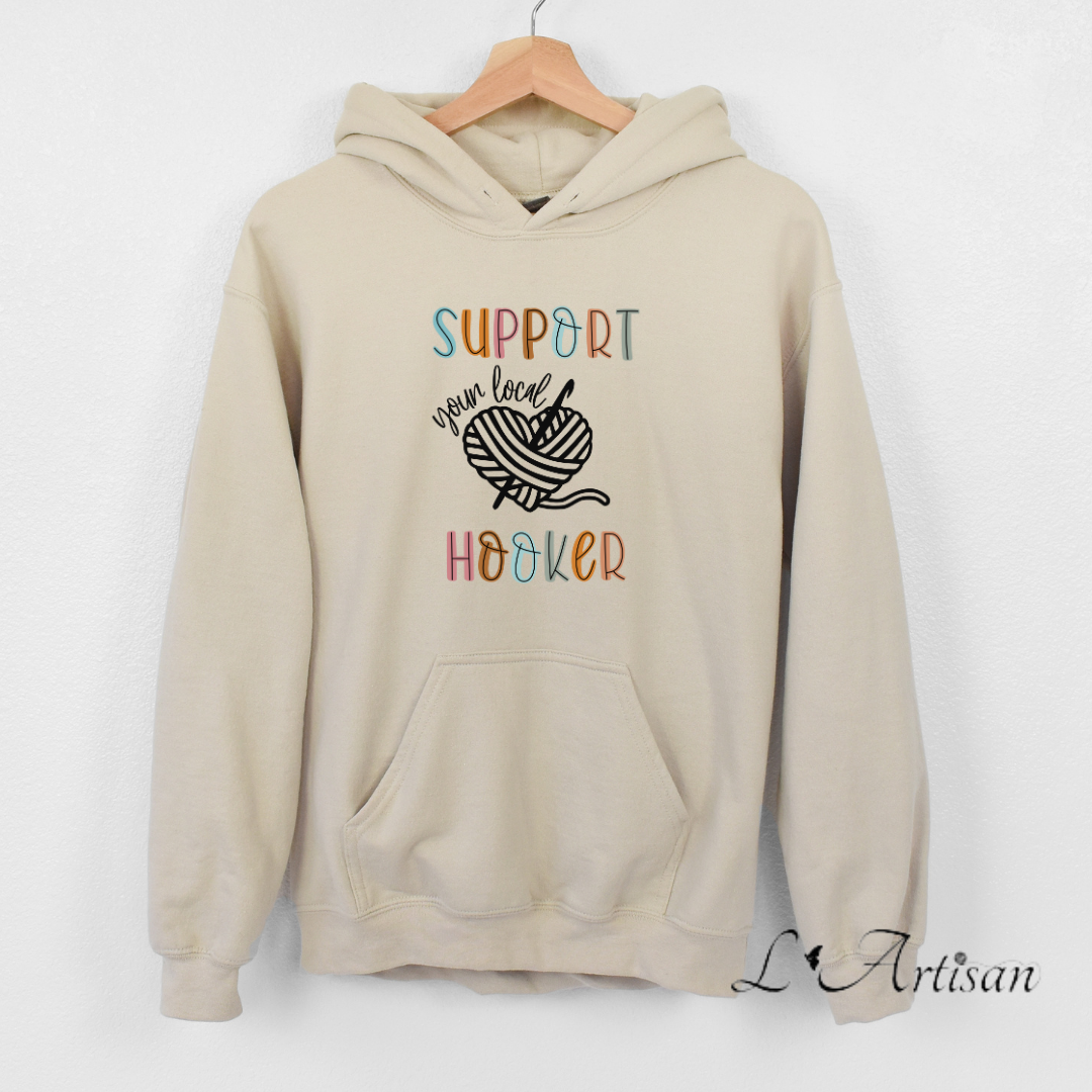 Beige Canadian hoodies with colorful 'Support Your Local Hooker' graphic design