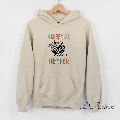 Beige Canadian hoodies with colorful 'Support Your Local Hooker' graphic design