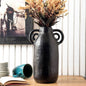 Elegant black aluminum vase from iDekor8 featuring unique handles, perfect for floral arrangements