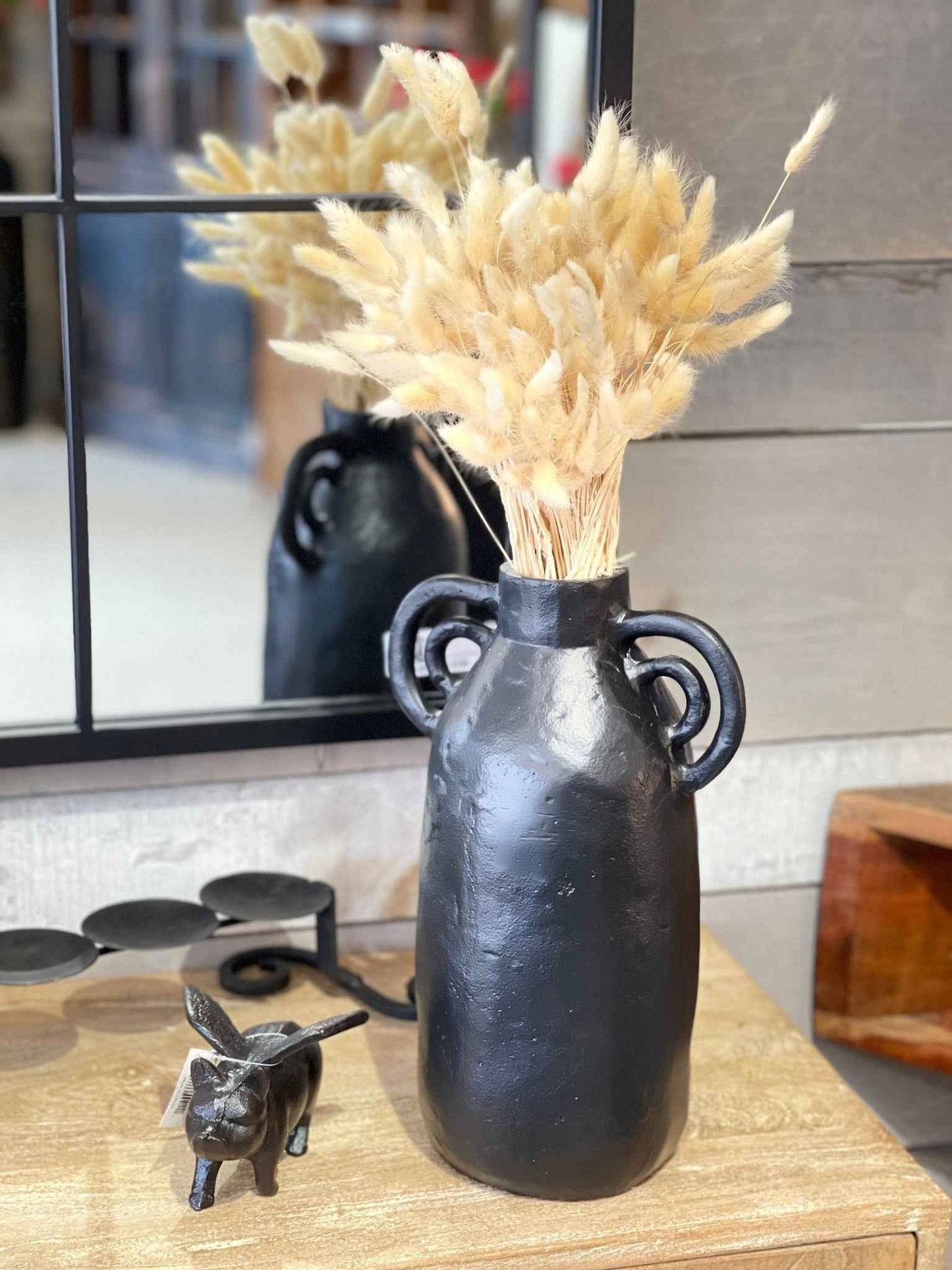 Stylish black aluminum vase with decorative handles, perfect for home decor and floral arrangements