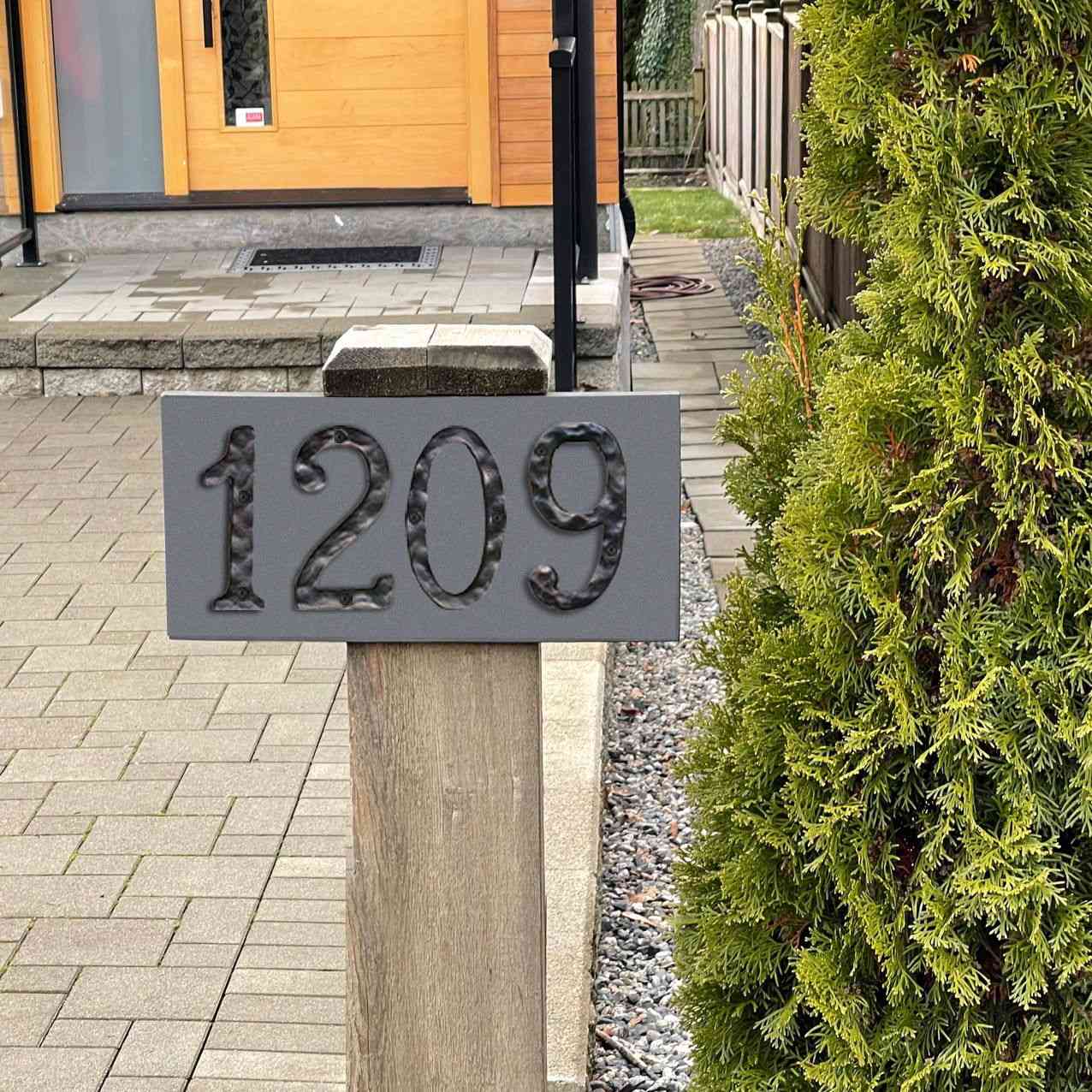 Black cast iron letter C on a stylish house address sign for modern home decor