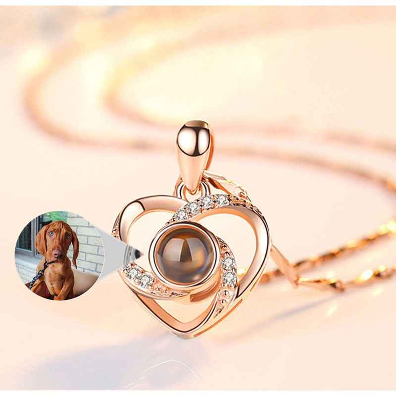 Custom pet necklace in heart shape with shimmering details and a picture of a dog inside
