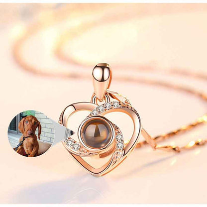 Custom pet necklace in heart shape with shimmering details and a picture of a dog inside