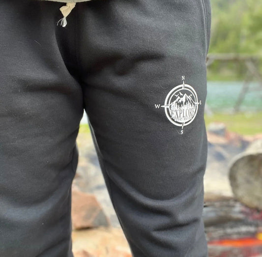 Explore Sweatpants Canada in black with a compass logo, perfect for outdoor adventures