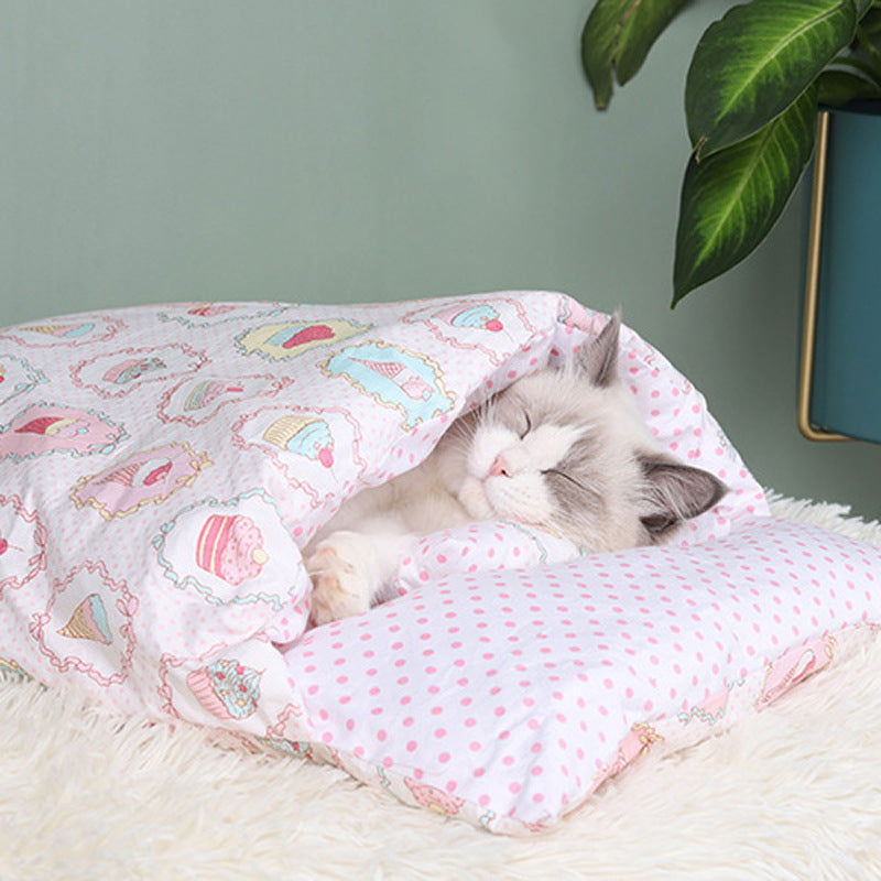Cozy futon style pet bed for cats with a pink quilted design and soft polka dot pillow