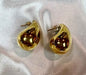 Unique gold earrings with a sleek teardrop design, perfect for stylish occasions