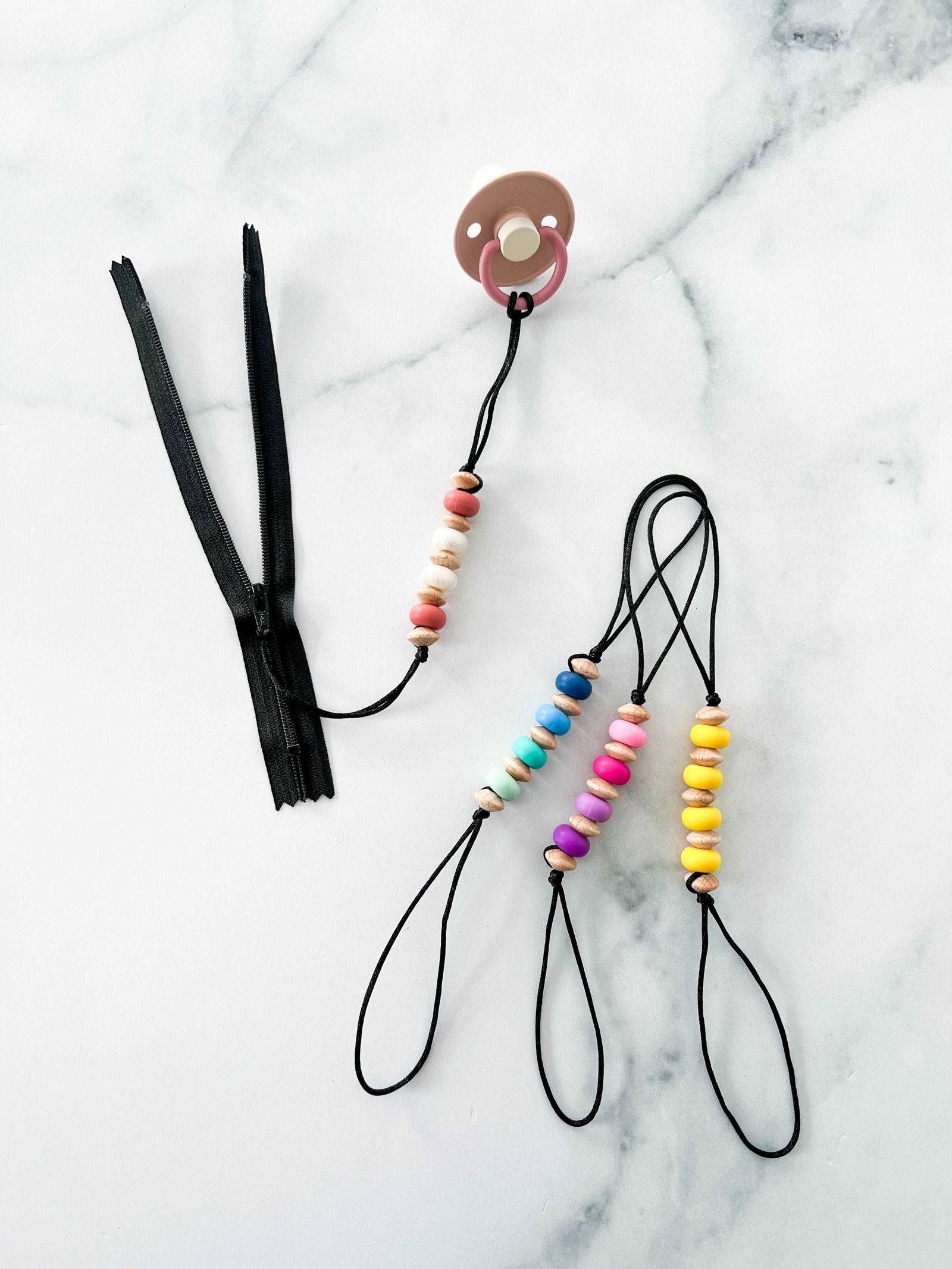 Creation Coco Lyly pacifier clip Canada with colorful wooden beads on a black cord