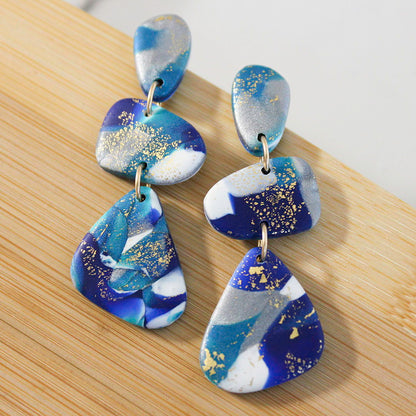 Alma Rosa polymer clay stone earrings in blue and gold with unique geometric design