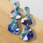 Alma Rosa polymer clay stone earrings in blue and gold with unique geometric design