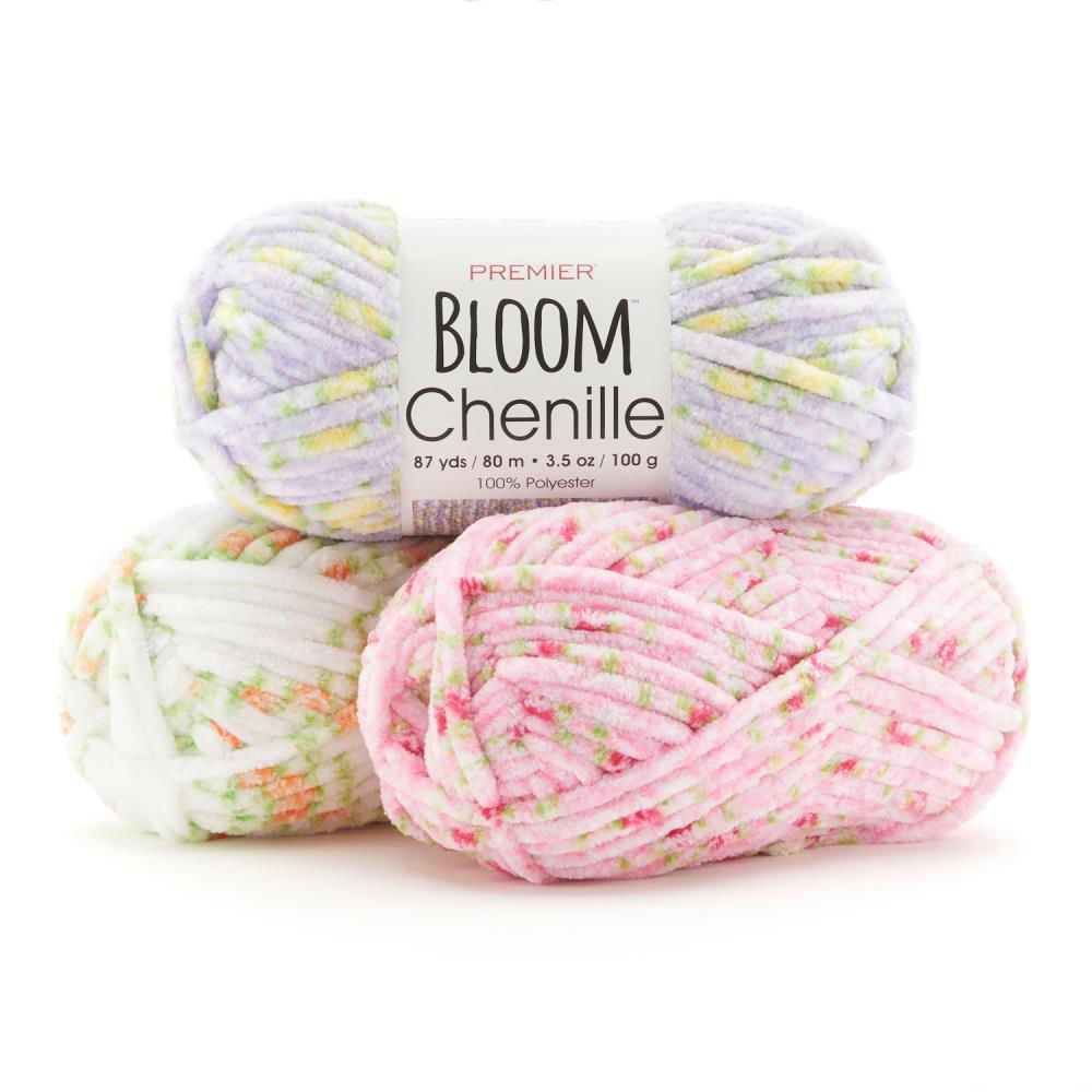 Three skeins of floral chenille yarn in pastel colors, perfect for knitting and crochet projects