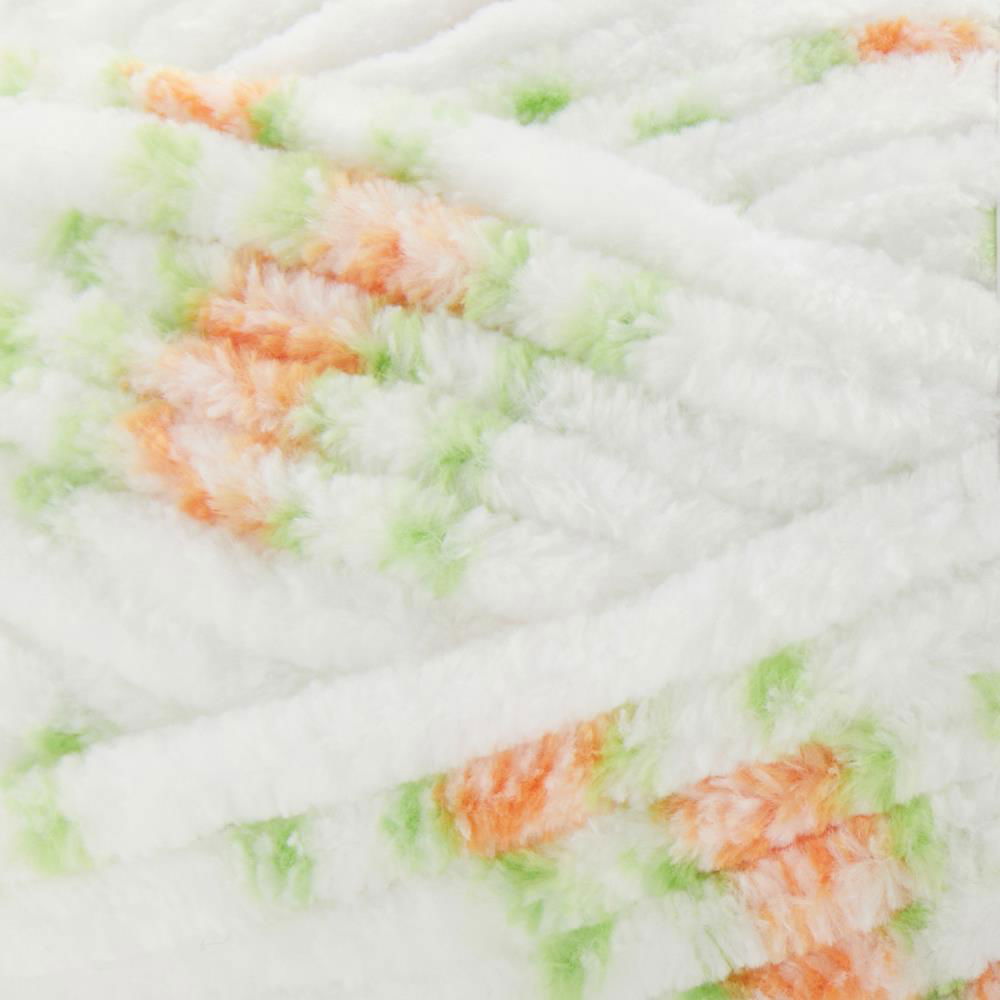 Soft floral chenille yarn in white with orange and green accents for crochet and knitting projects