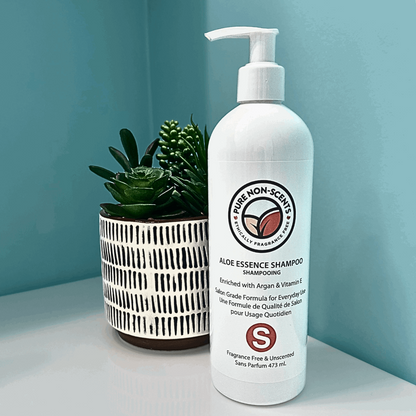 Aloe Essence Shampoo with Vitamin E from Pure Non-Scents in a stylish bottle on a bathroom shelf