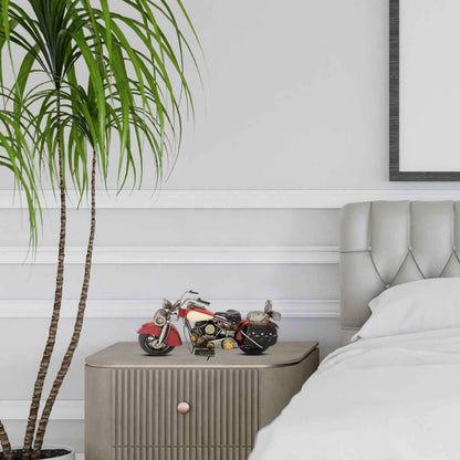 Decorative red motorcycle model displayed on a nightstand in a modern bedroom setting
