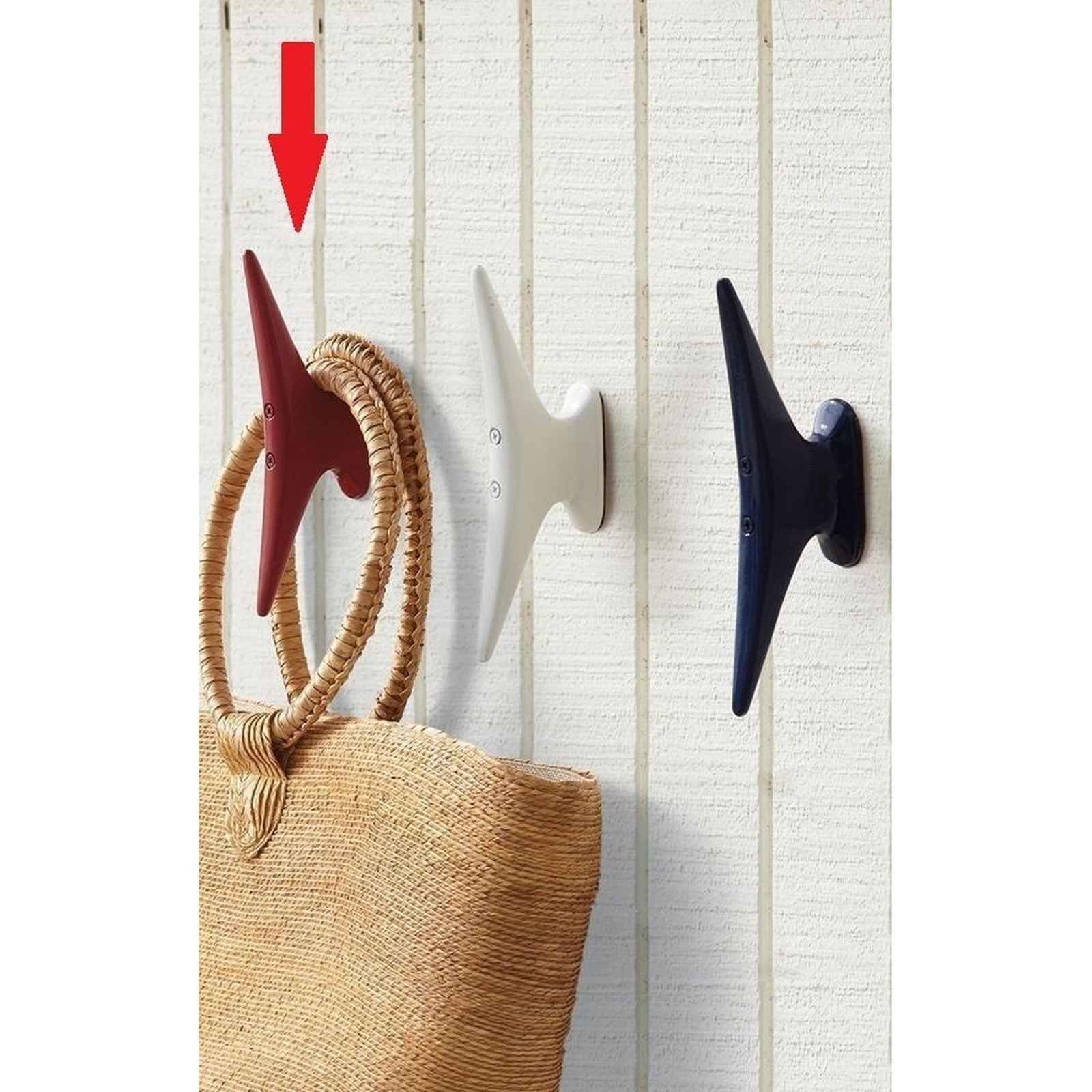 Red nautical cleat hook on a white wall, ideal for hanging bags and home decor items