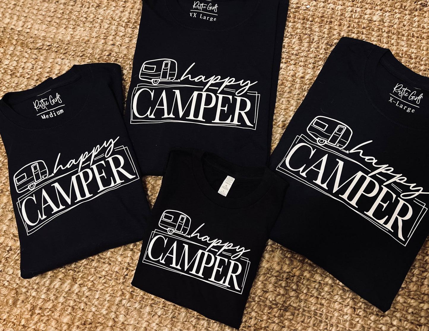 Collection of Happy Camper t-shirts in various sizes featuring stylish camper design