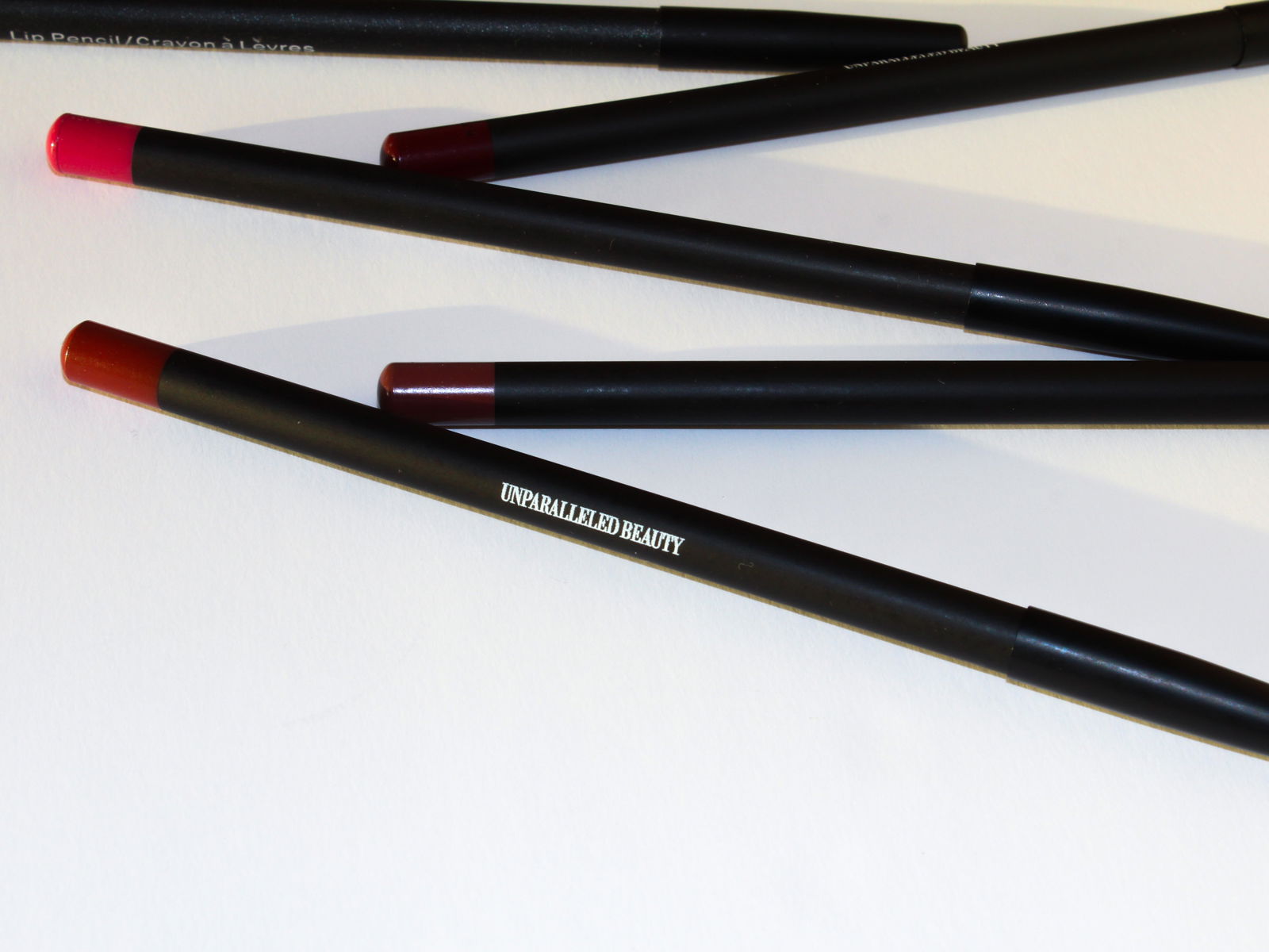 Four UNPARALLELED BEAUTY lip pencils including the sweet spice lip pencil in vibrant shades