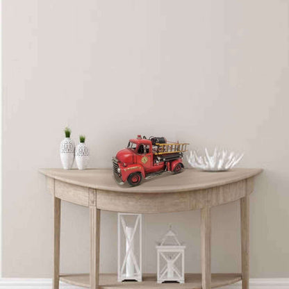 Vintage fire truck model displayed on a stylish table with decorative items
