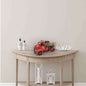 Vintage fire truck model displayed on a stylish table with decorative items