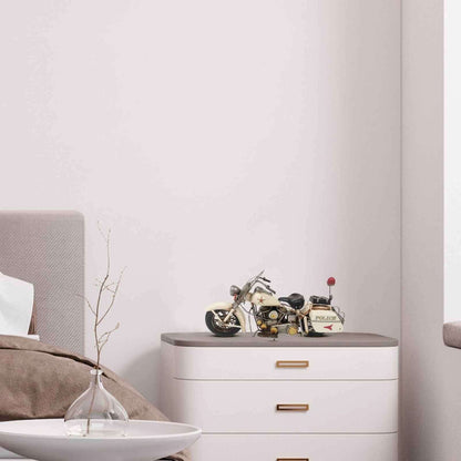 Vintage police motorcycle model displayed on a modern dresser in a stylish bedroom setting