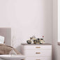 Vintage police motorcycle model displayed on a modern dresser in a stylish bedroom setting