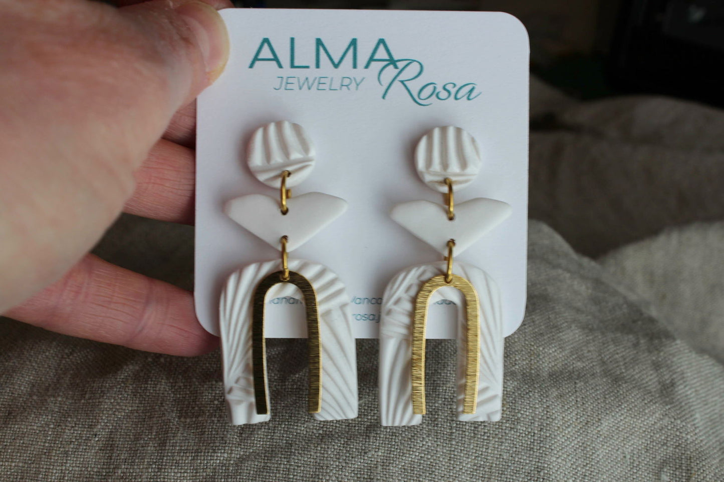 Elegant white polymer clay earrings by Alma Rosa Jewelry featuring unique shapes and gold accents