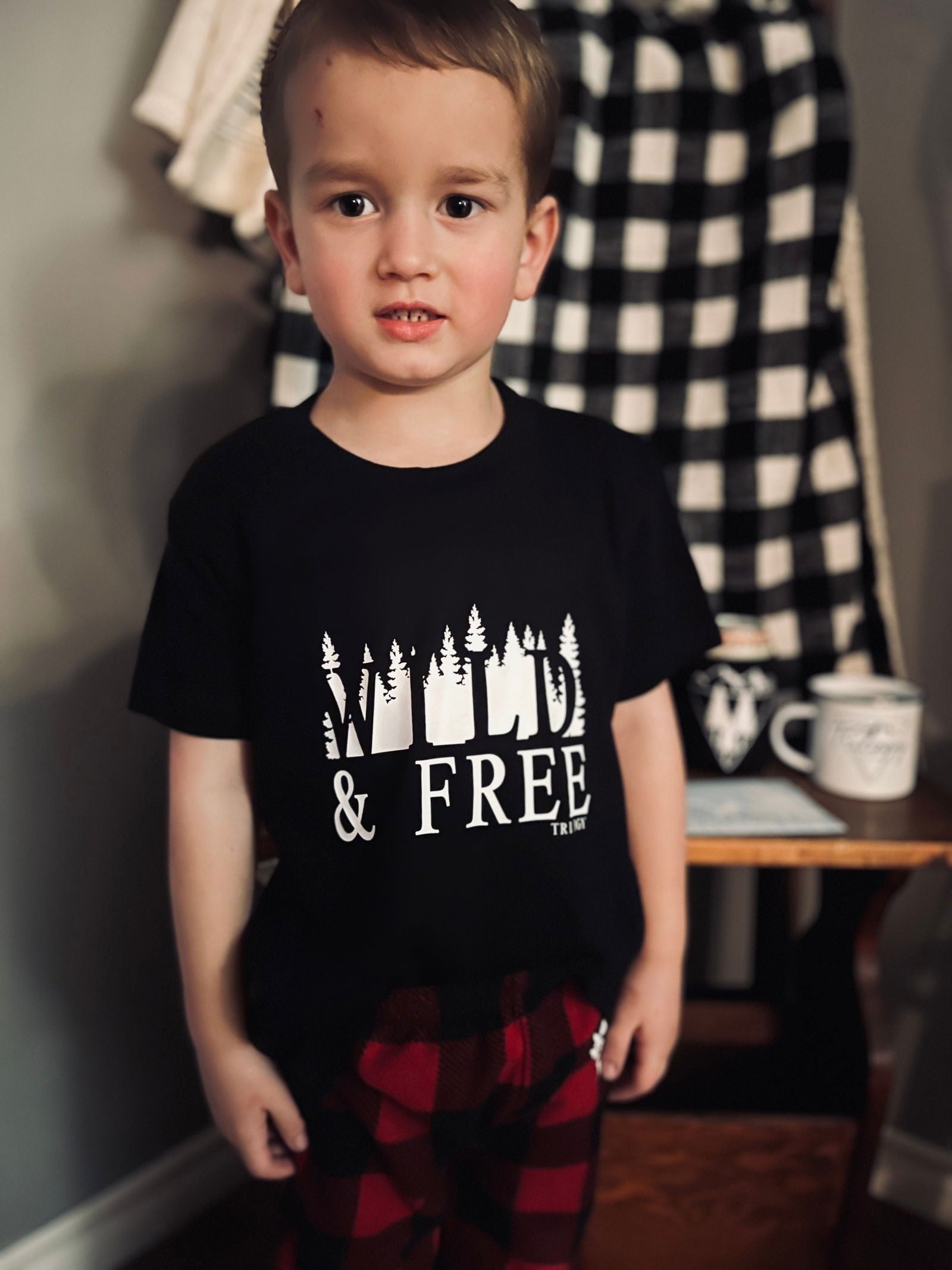 Wild and Free kids t-shirt in black, designed for adventurous little ones with a playful forest print